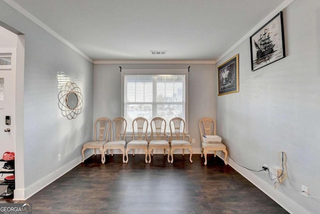 sitting room featuring crown molding and dark hardwood / wood-style flooring