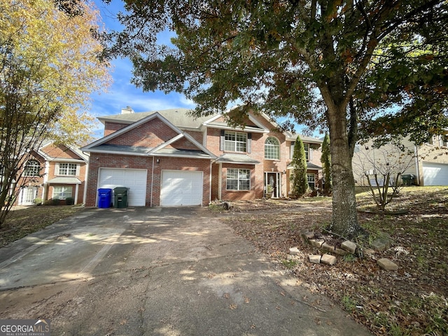 1529 Evergreen Hollow Ln, Conyers, GA 30012 - traditional-style home featuring brick siding, an attached garage, asphalt driveway, and a chimney