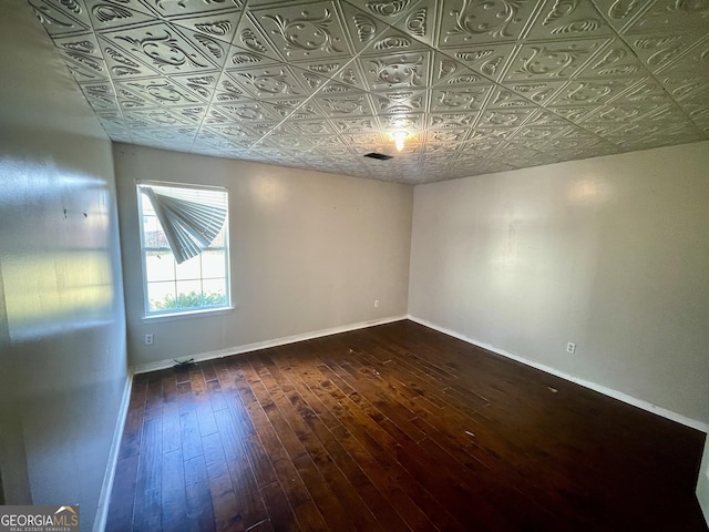 1529 Evergreen Hollow Ln, Conyers, GA 30012 - spare room featuring dark wood-style floors, baseboards, and an ornate ceiling