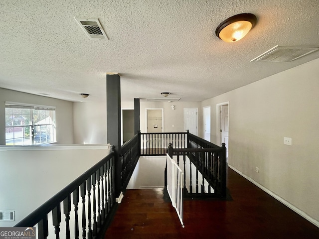 1529 Evergreen Hollow Ln, Conyers, GA 30012 - hall featuring an upstairs landing, a textured ceiling, and wood finished floors