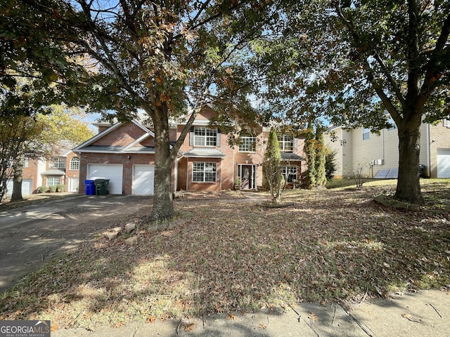 1529 Evergreen Hollow Ln, Conyers, GA 30012 - view of front of house with a garage, brick siding, and asphalt driveway