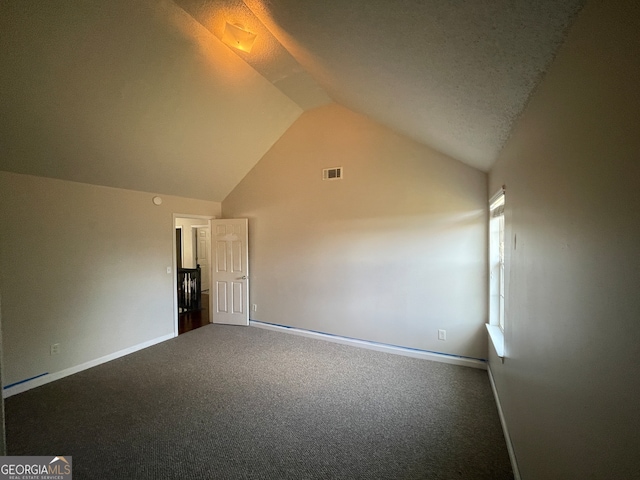 additional living space with carpet flooring and lofted ceiling