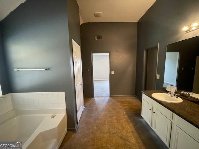 bathroom featuring a tub to relax in and vanity