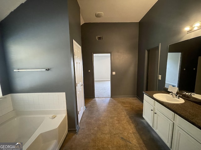 1529 Evergreen Hollow Ln, Conyers, GA 30012 - bathroom featuring a garden tub, vanity, a towering ceiling, and baseboards