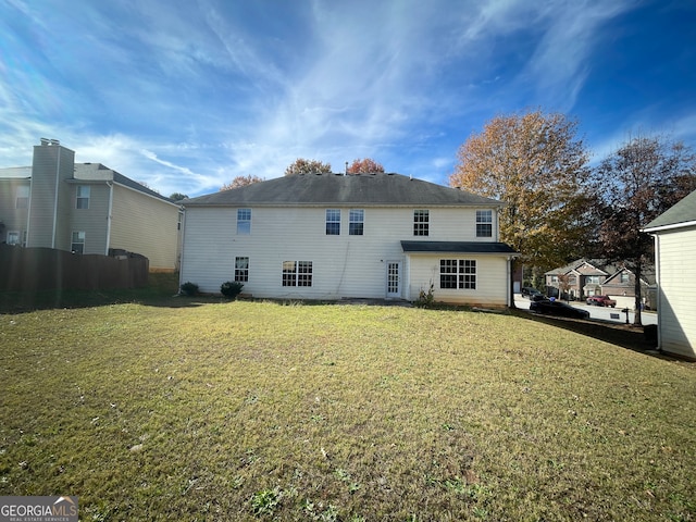 back of property featuring a lawn