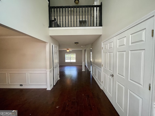 1529 Evergreen Hollow Ln, Conyers, GA 30012 - corridor featuring hardwood / wood-style floors, a decorative wall, a high ceiling, and a wainscoted wall