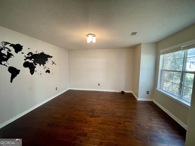 1529 Evergreen Hollow Ln, Conyers, GA 30012 - unfurnished room featuring dark wood-style flooring, a textured ceiling, and baseboards
