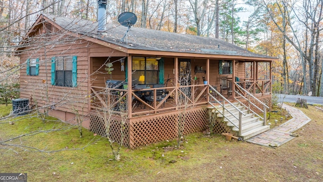 rear view of property with central AC and covered porch