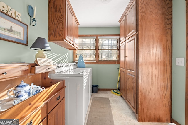 laundry room featuring cabinets, independent washer and dryer, and light tile patterned floors