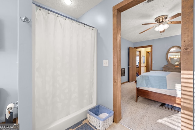 bathroom with ceiling fan, a textured ceiling, and a shower with shower curtain