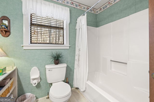 bathroom with shower / bath combination with curtain and toilet