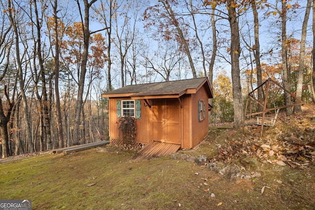 view of outbuilding featuring a lawn