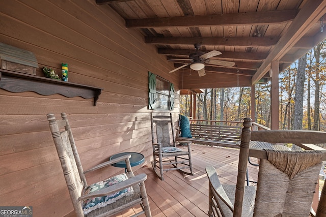 wooden deck featuring ceiling fan and covered porch