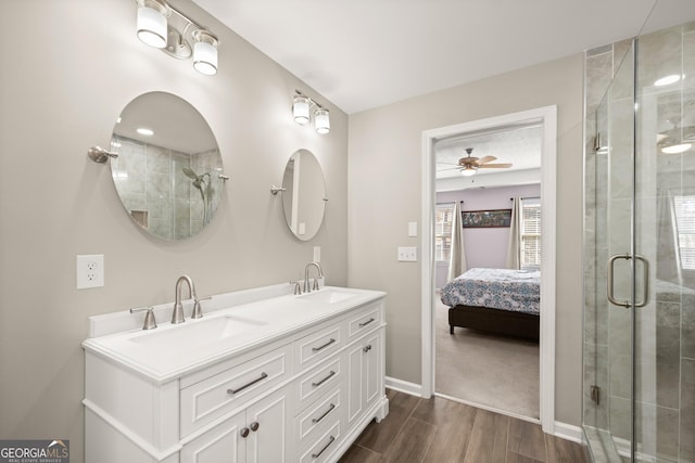 bathroom featuring ceiling fan, plenty of natural light, wood-type flooring, and a shower with door