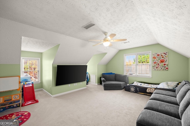 living room with carpet, a textured ceiling, ceiling fan, and lofted ceiling