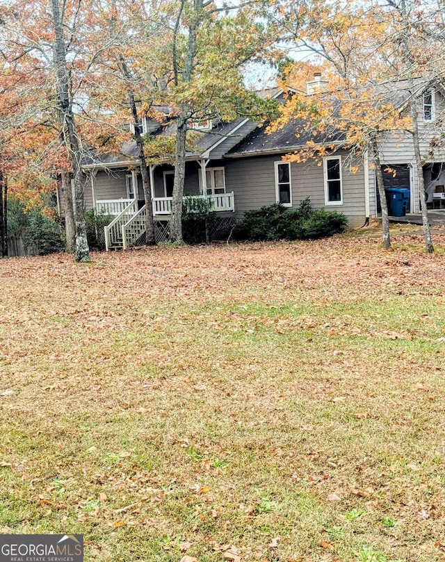 view of front of home with a porch and a front yard