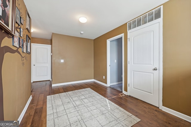 unfurnished room featuring dark wood-type flooring