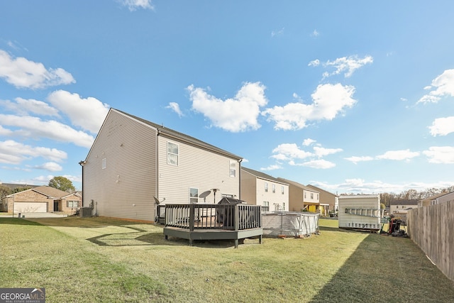 rear view of property featuring a swimming pool side deck, a yard, and central AC