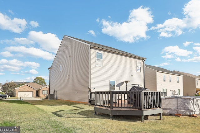 back of house with cooling unit, a deck, and a yard