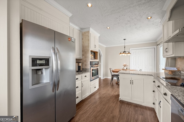 kitchen with white cabinets, appliances with stainless steel finishes, light stone countertops, and pendant lighting