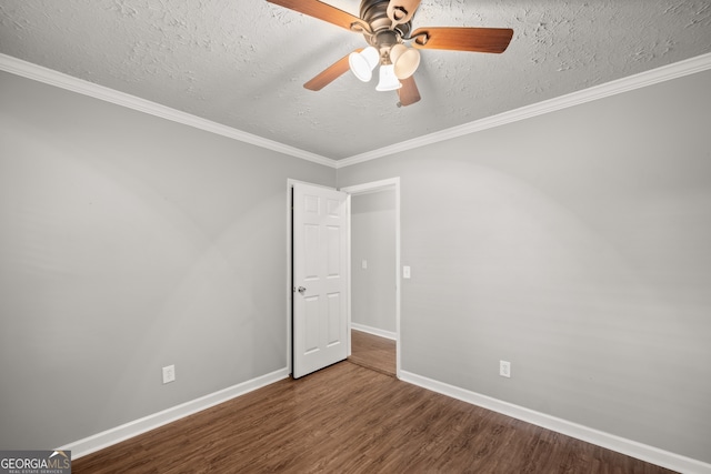 spare room featuring ceiling fan, wood-type flooring, a textured ceiling, and ornamental molding