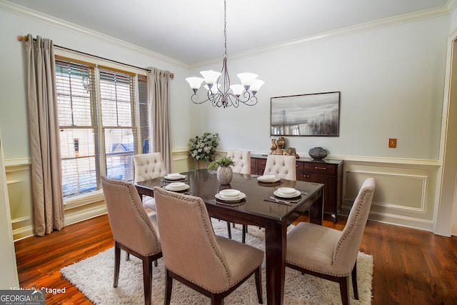 dining room featuring dark hardwood / wood-style flooring, crown molding, and a chandelier