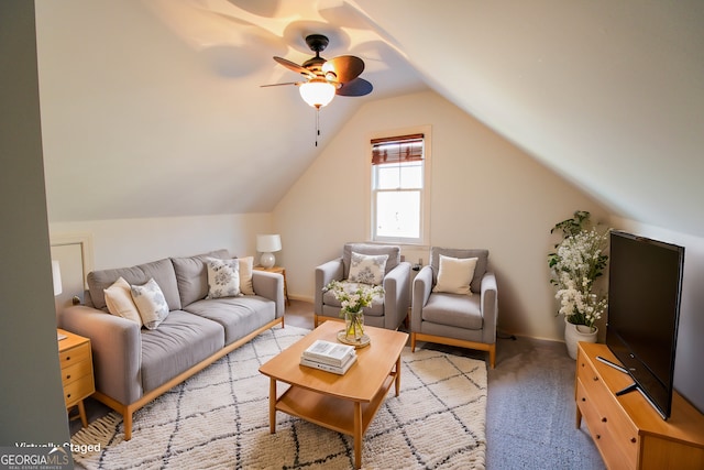 living room with ceiling fan, light colored carpet, and vaulted ceiling