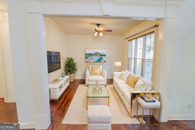 living room with crown molding, dark wood-type flooring, and ceiling fan