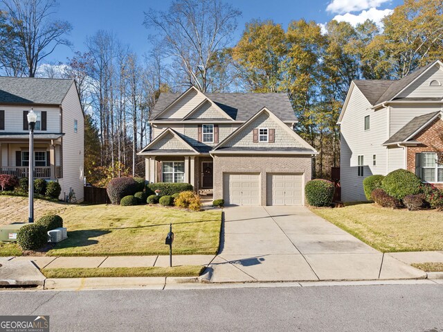 view of front of home featuring a garage and a front lawn