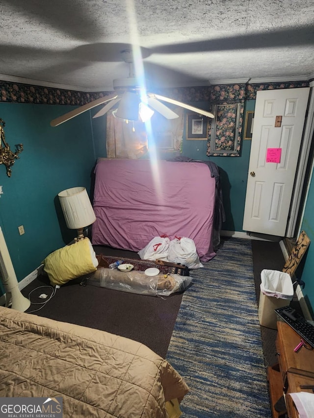 carpeted bedroom with ceiling fan and a textured ceiling