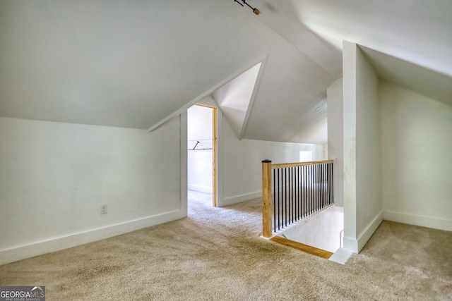 bonus room with light carpet and lofted ceiling