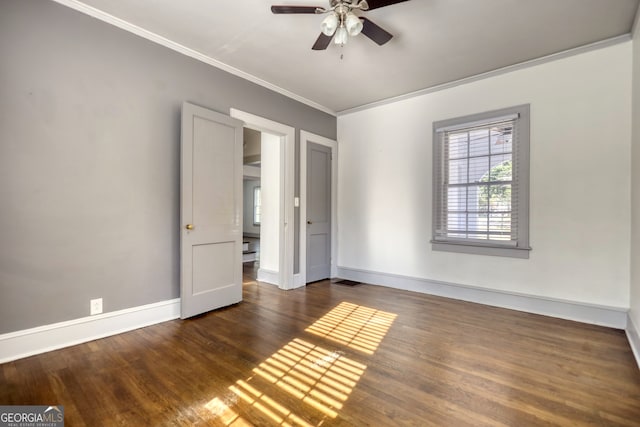 unfurnished room with crown molding, ceiling fan, and dark wood-type flooring