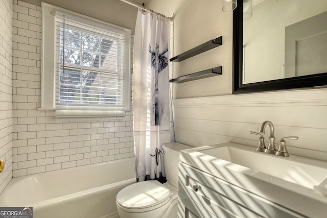 full bathroom featuring shower / bath combination with curtain, toilet, and sink