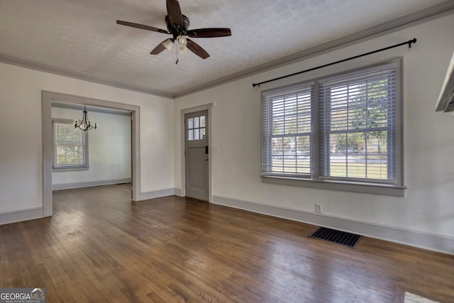 interior space with a textured ceiling, ceiling fan with notable chandelier, ornamental molding, and dark wood-type flooring