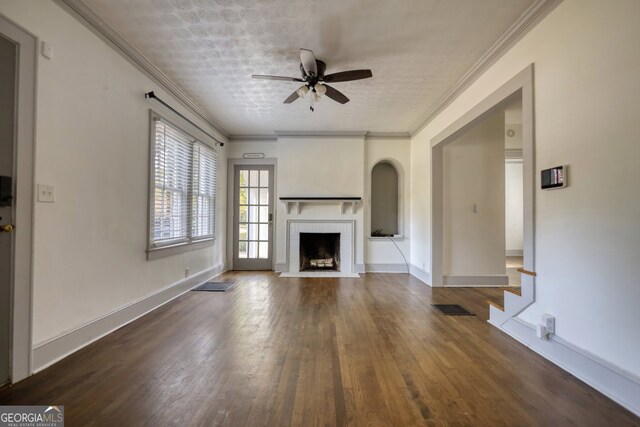 unfurnished living room featuring a textured ceiling, ceiling fan, ornamental molding, and dark wood-type flooring