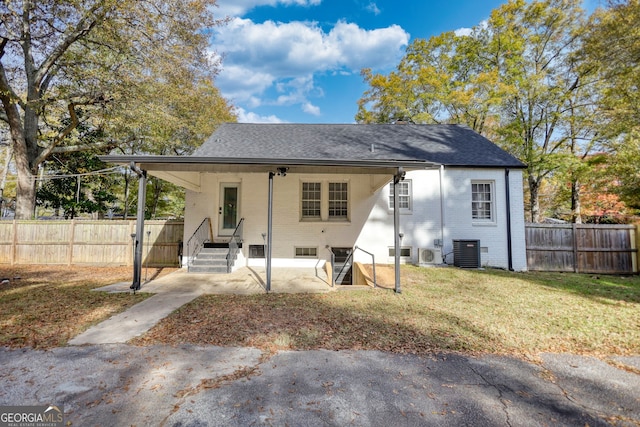 back of property with a yard and cooling unit