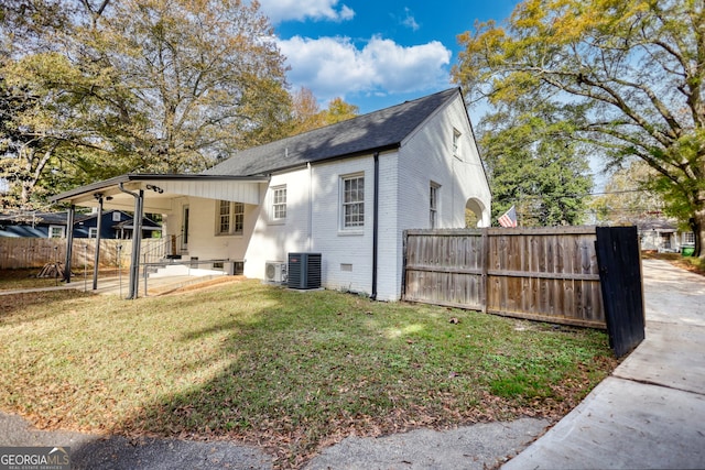 view of property exterior with a yard and central air condition unit