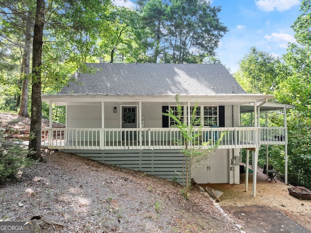 rear view of property with a garage