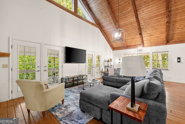 living room with french doors, high vaulted ceiling, and plenty of natural light