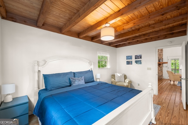 bedroom with hardwood / wood-style floors, wooden ceiling, and beamed ceiling