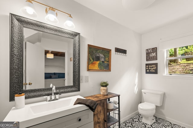 bathroom featuring tile patterned floors, vanity, and toilet