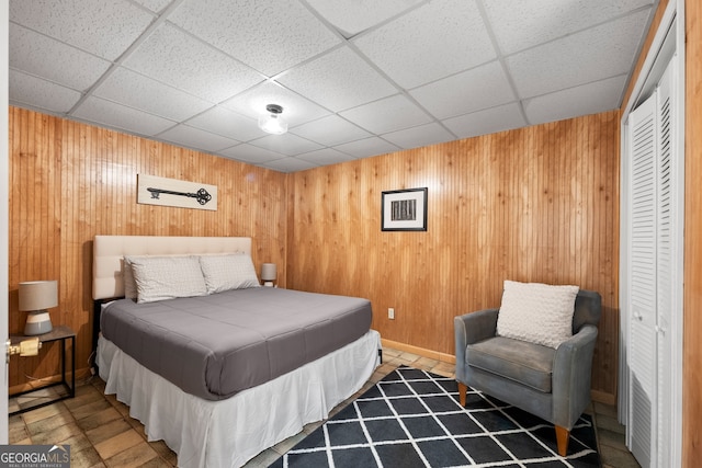 bedroom with a closet and a drop ceiling