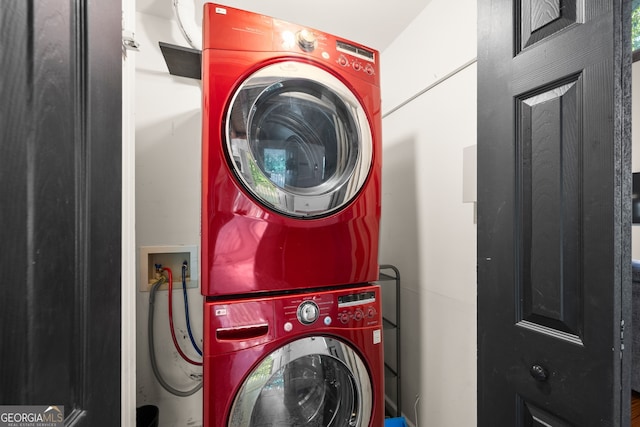 laundry room featuring stacked washer / drying machine