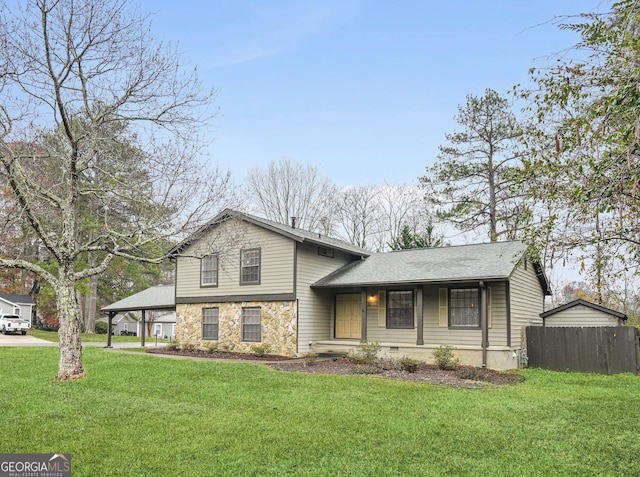 tri-level home with a porch, a front yard, and a carport