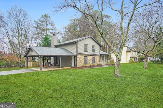 view of front of house with a carport and a front lawn