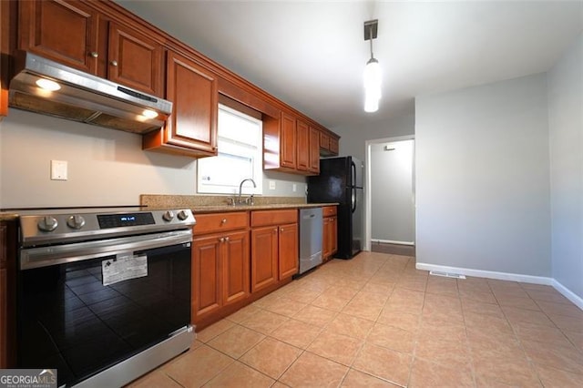 kitchen with sink, light tile patterned floors, stainless steel appliances, and hanging light fixtures