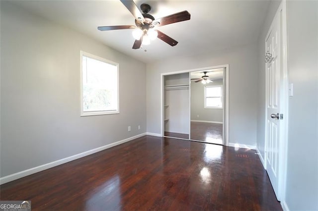 unfurnished bedroom with a closet, dark hardwood / wood-style floors, and ceiling fan