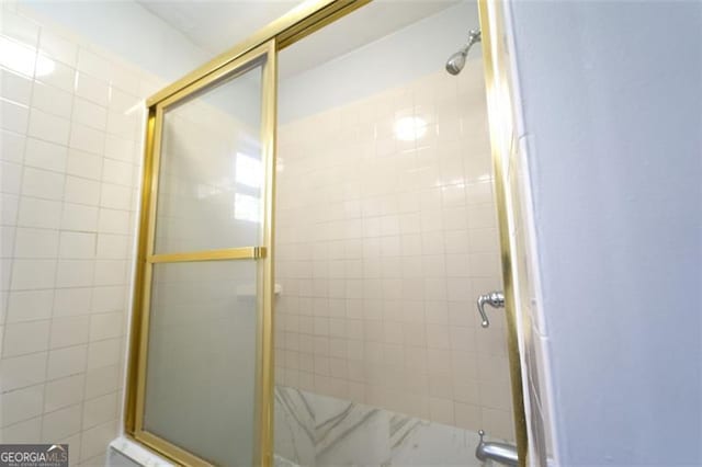 bathroom with a shower with door