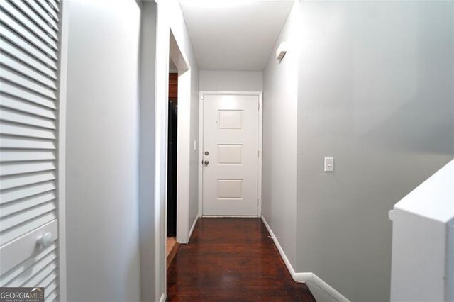 hall with dark wood-type flooring