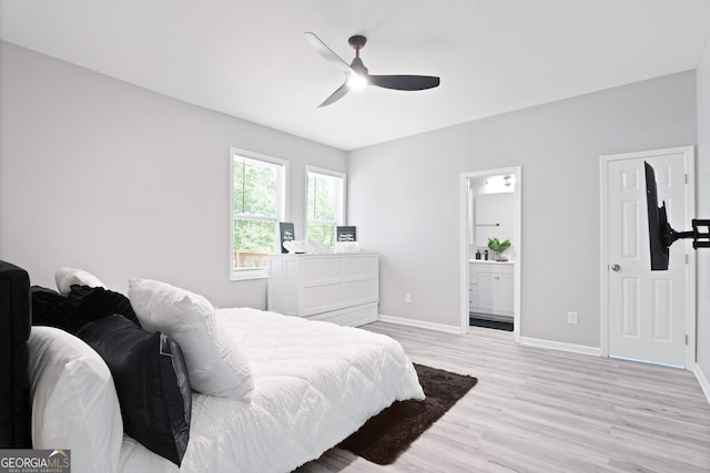 bedroom with ensuite bath, ceiling fan, and light hardwood / wood-style flooring